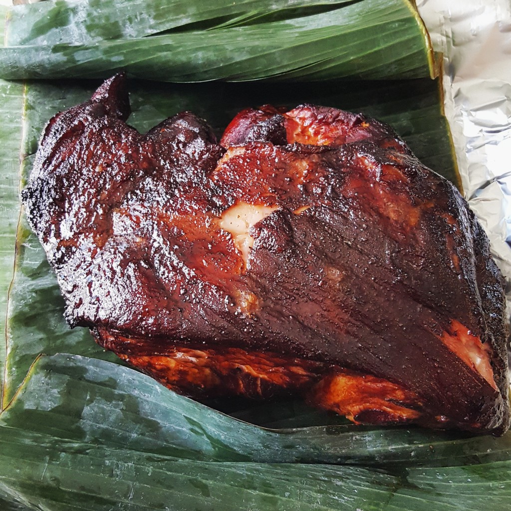 Pulled from the smoker after five hours and placed directly on the banana leaves.