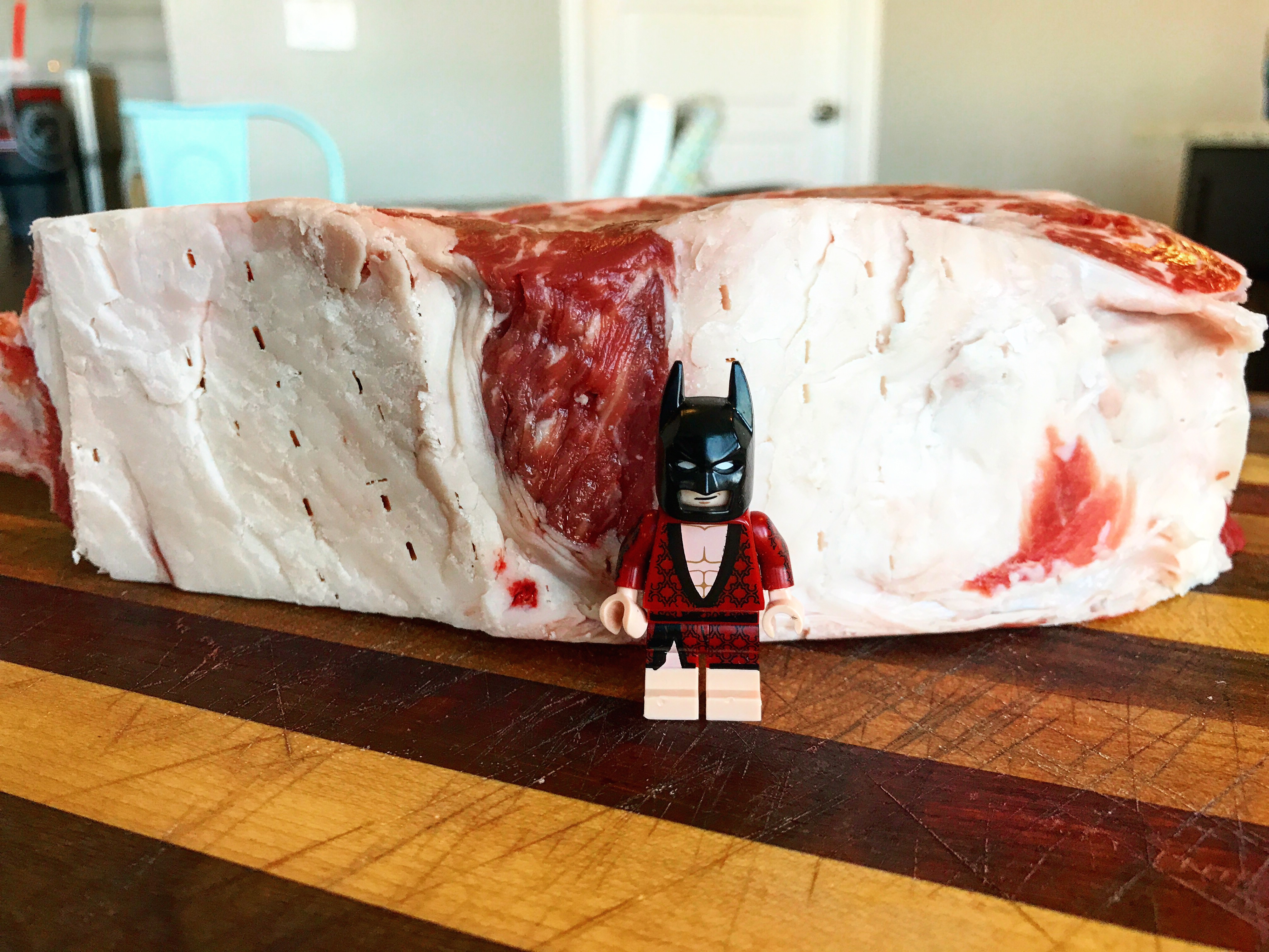 Lego Batman is about 1 3/4" tall. The thickness of the steak rises above the Dark Knight!