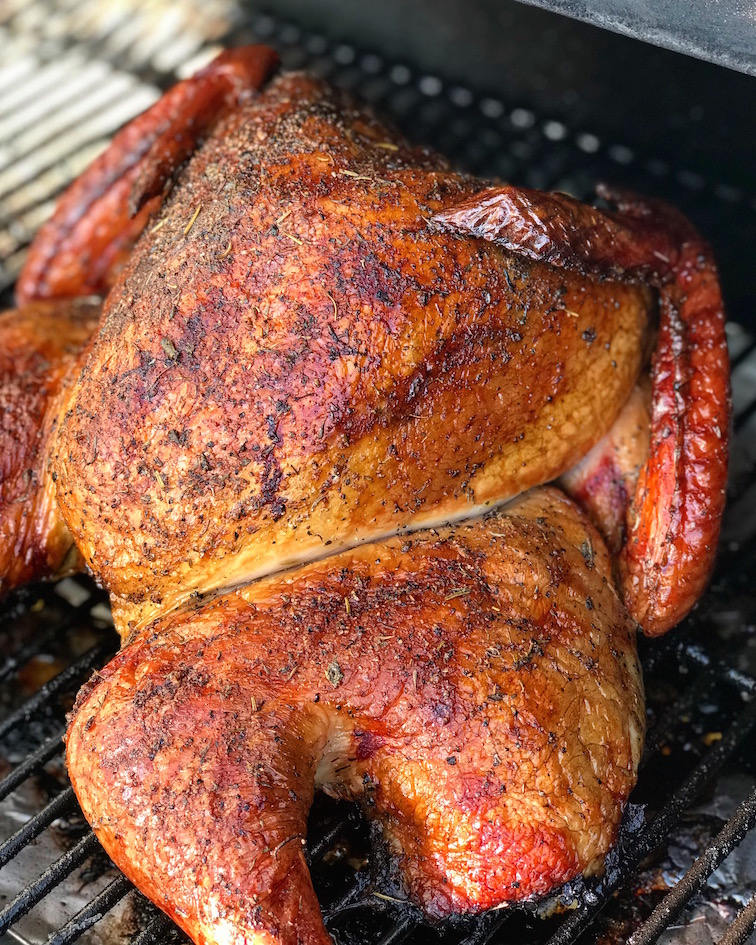 Smoked turkey finishing on the grill.