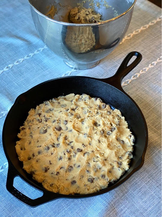 Chocolate chip cookie dough pressed evenly into the skillet and ready to hit the grill.