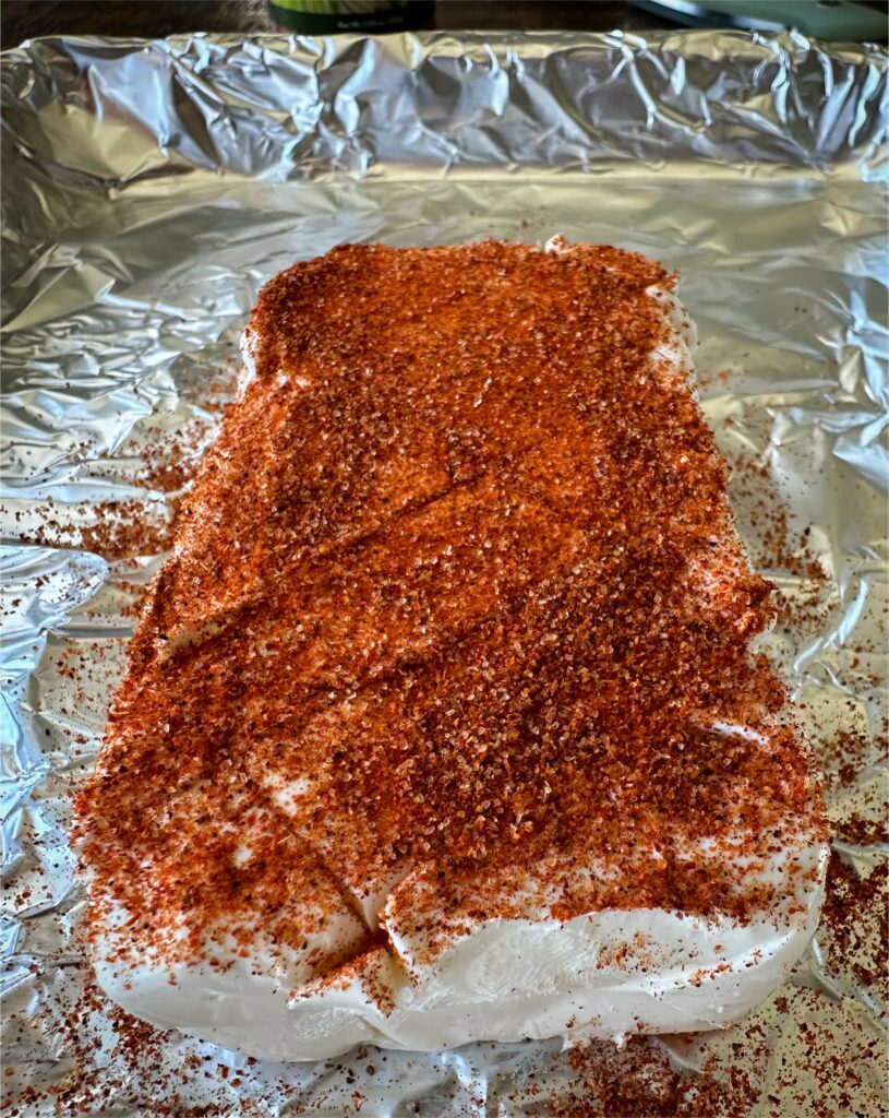 Brick of cream cheese scored and seasoned with chili lime. 