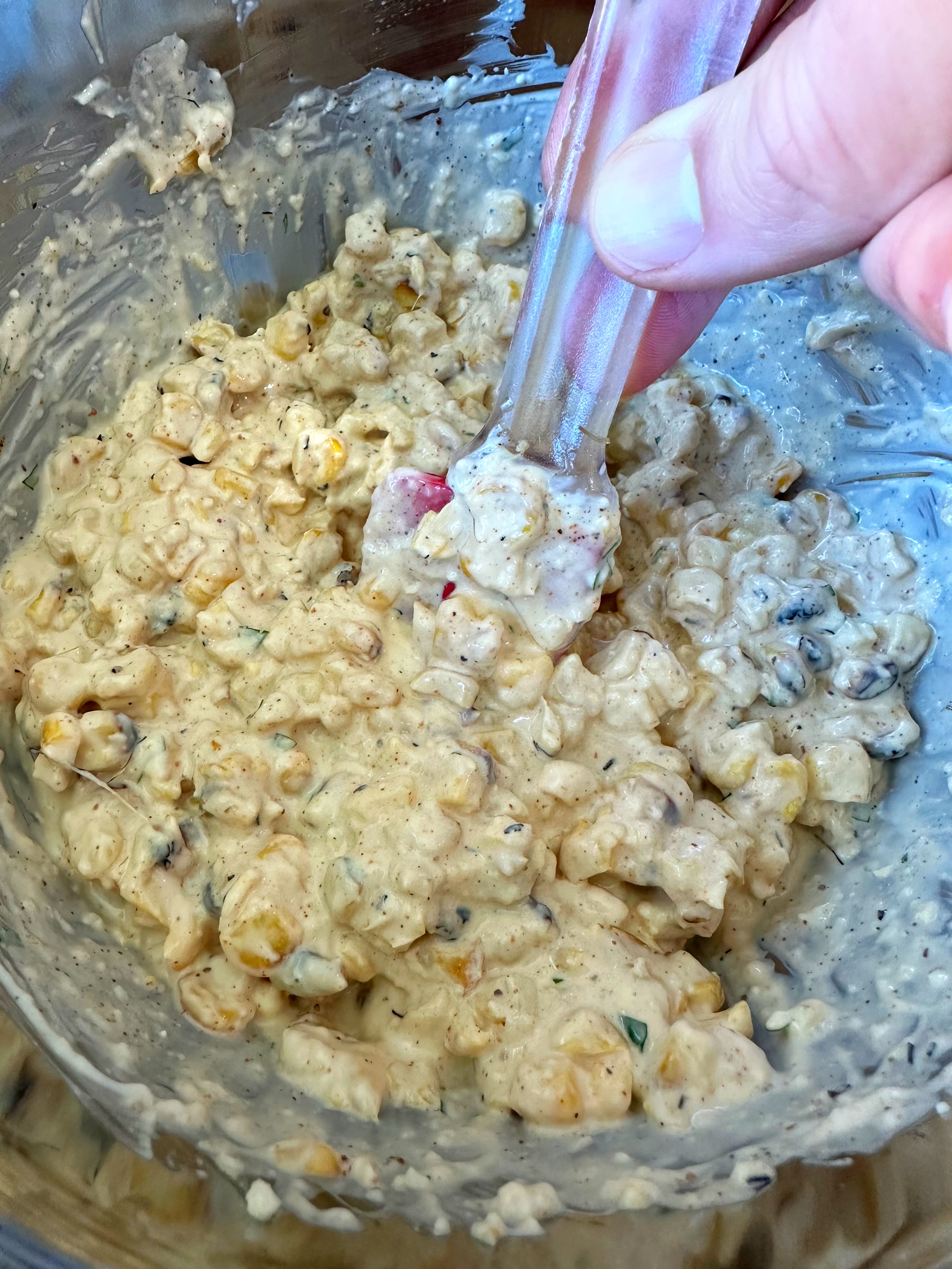 Mixing all of the elotes dip ingredients together. 