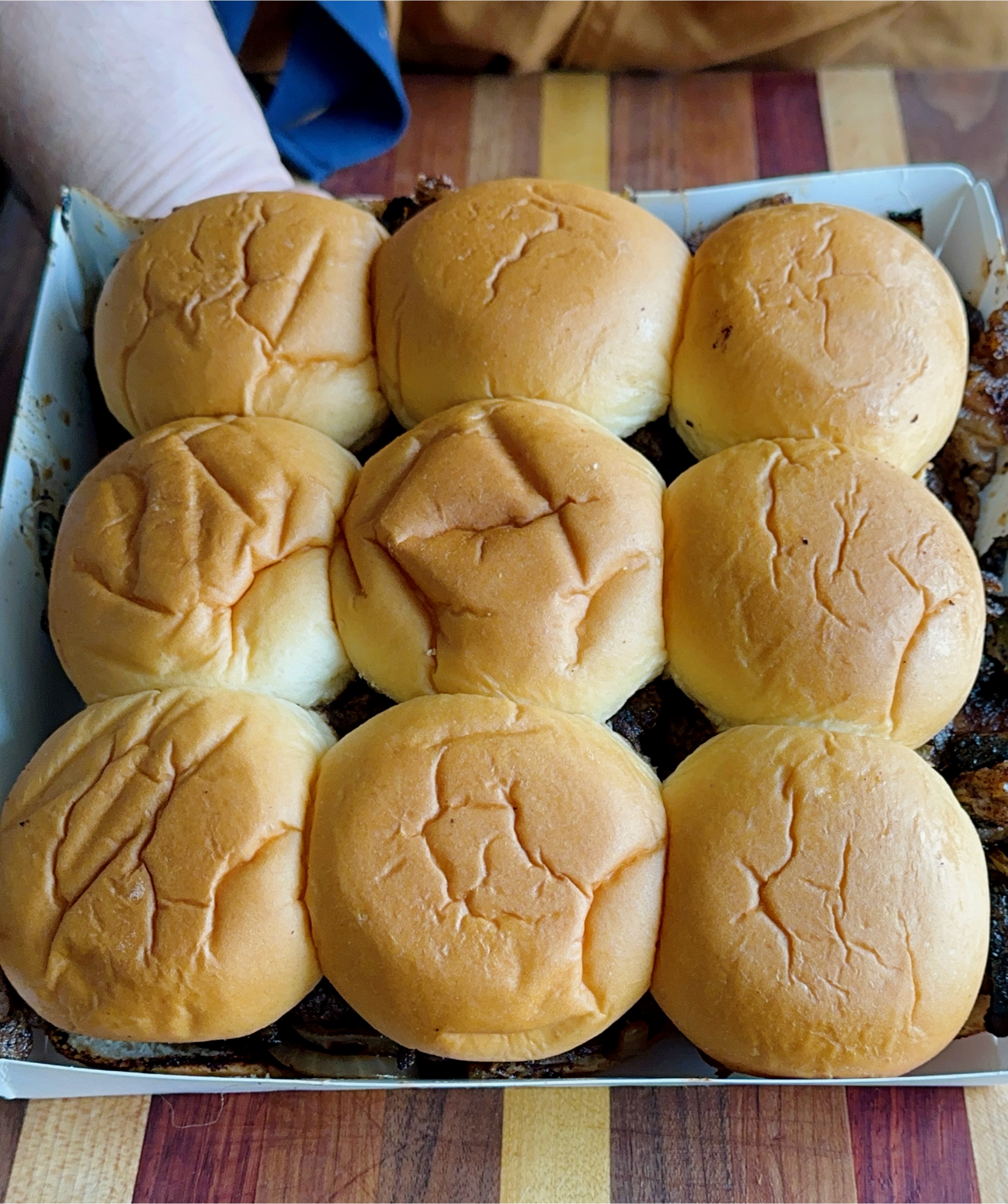 Hawaiian roll sliders assembled in the tray. 
