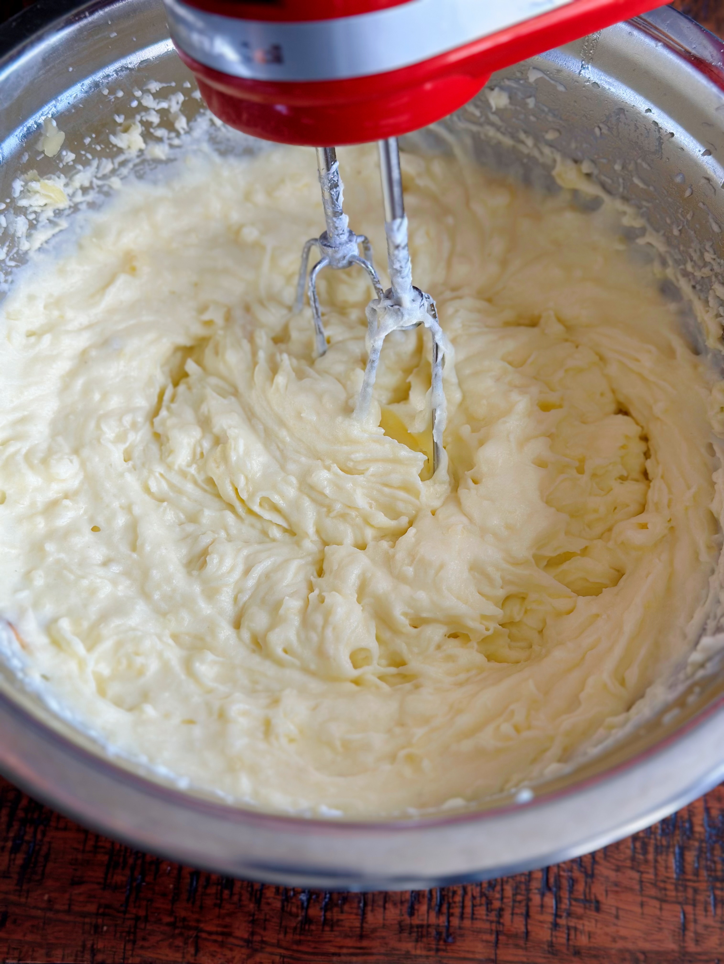 Using a hand mixer to mash potatoes. 